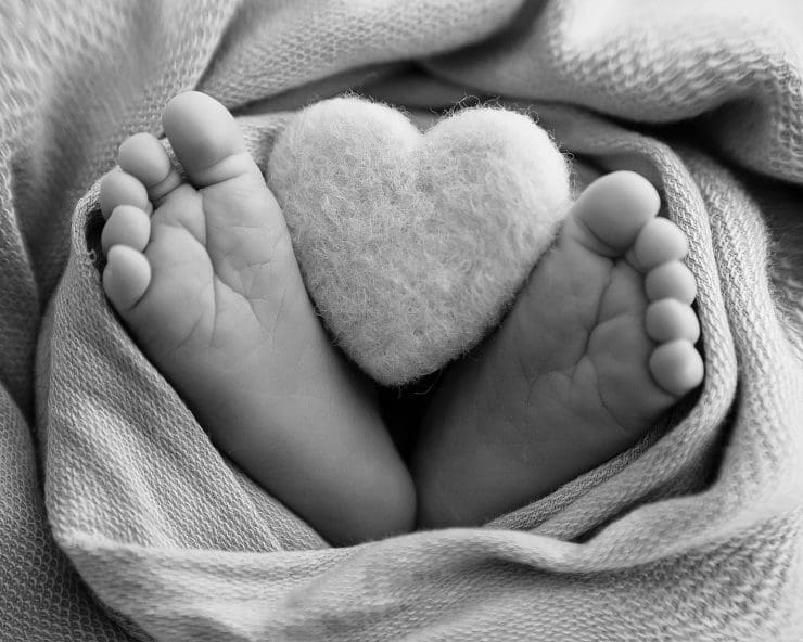 close up black and white photo of babies toes
