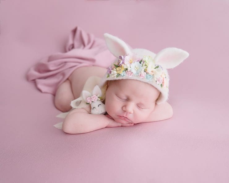 newborn baby ada rose on pink blanket with bunny hat on