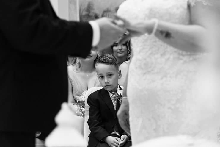 black and white photos holding hands at the altar