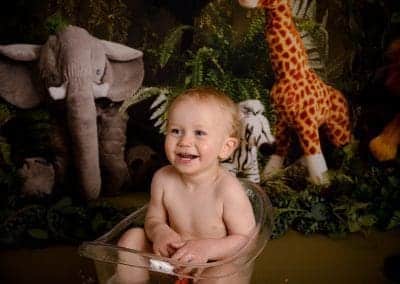 little boy laughing in the tub