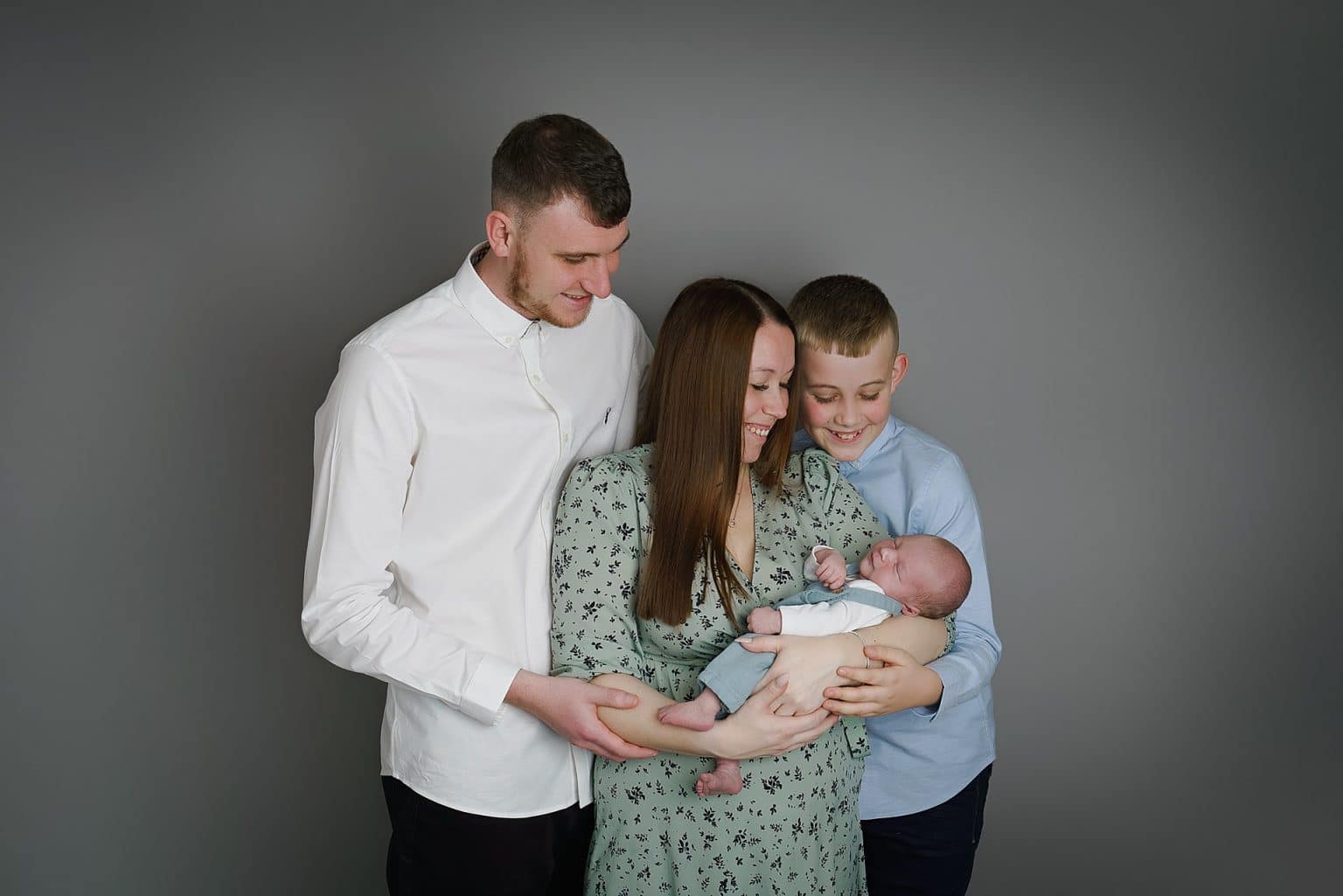 beautiful family photo, mum,dad, big brother and newborn baby