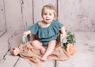 cute girl sat in a chair wearing blue during her sitters photography session