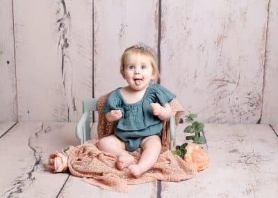 cute girl sat in a chair wearing blue during her sitters photography session