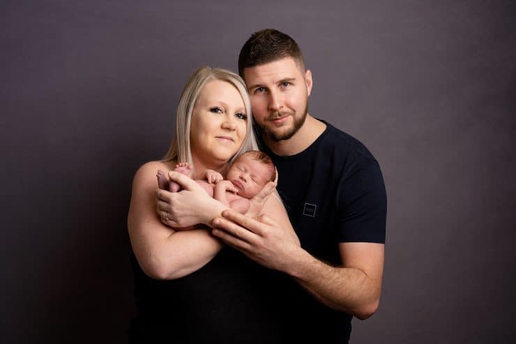 mum and dad with Newborn baby posing