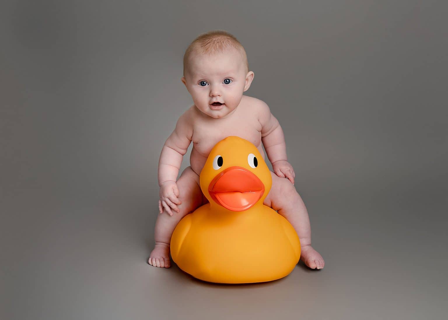 cute naked girl sat on a duck