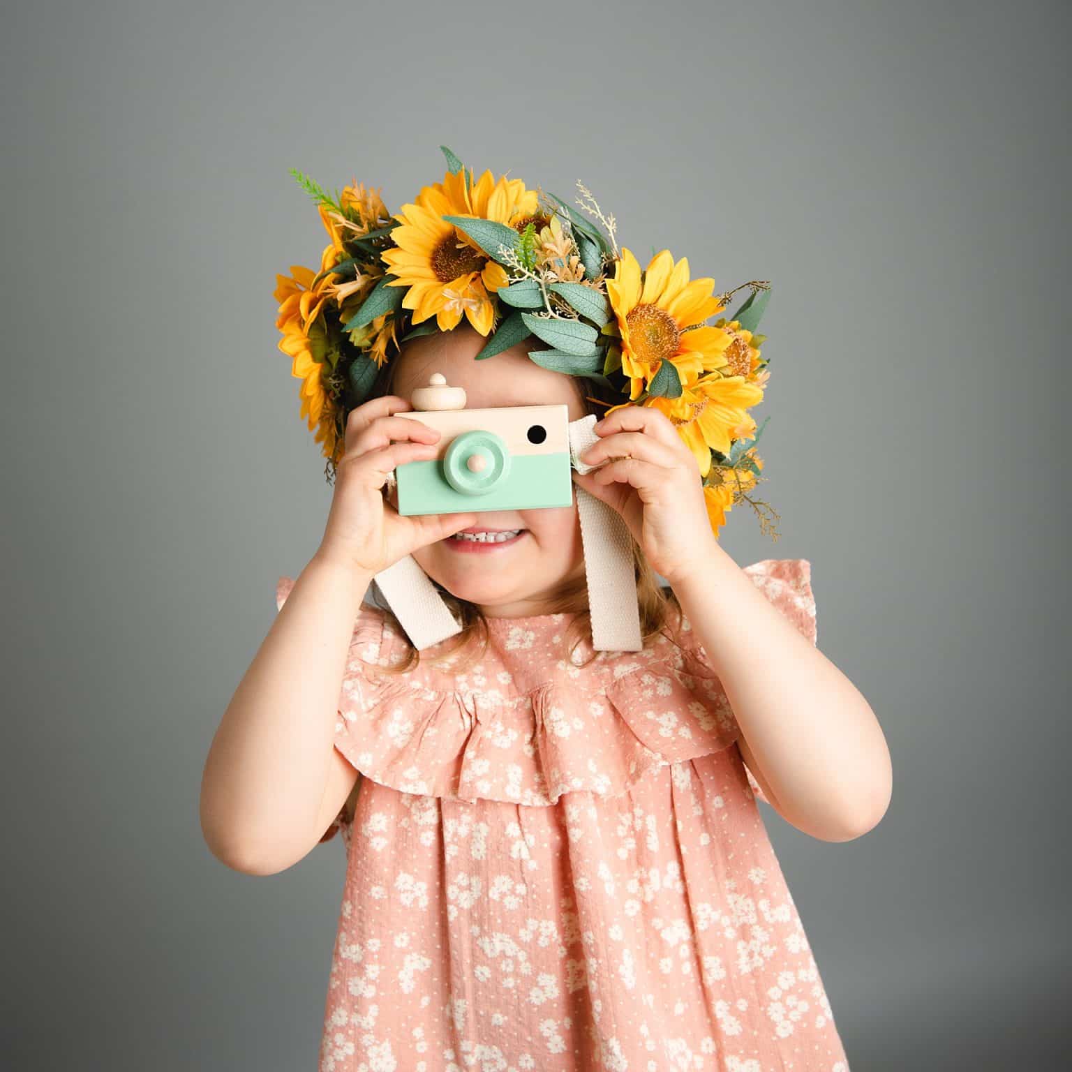 snap! little girl taking a photo with toy camera