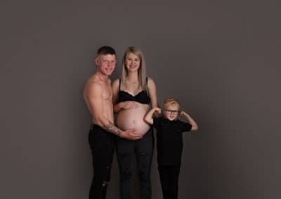 beautiful mummy to be with her family on her maternity session. big brother showing his muscles off