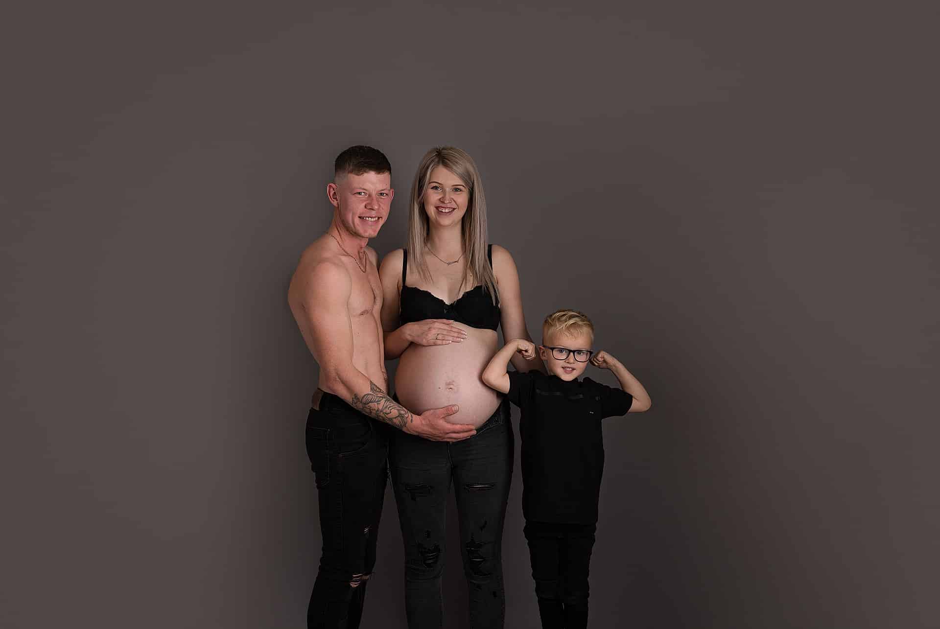 beautiful mummy to be with her family on her maternity session. big brother showing his muscles off