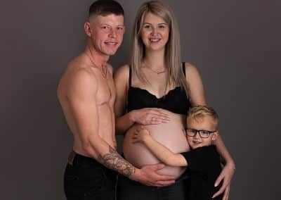 beautiful family while having a maternity session looking lovely, wearing black
