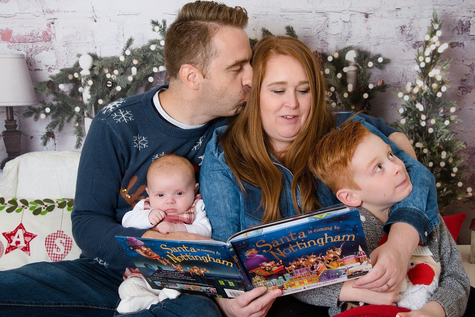 my crazy family at a christmas session reading a book on a bed