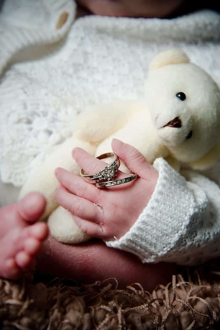 newborn baby harper with mum and dads wedding rings