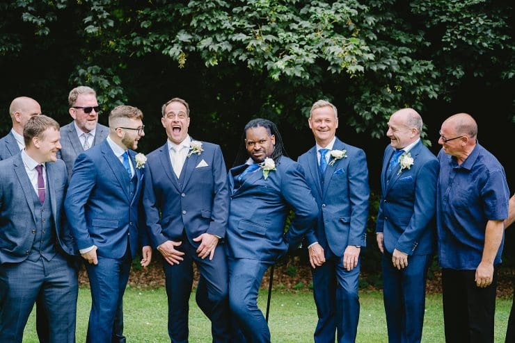 groomsmen with his merry men at his wedding all laughing and smling