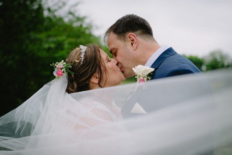 veil shoot kissing bride and groom at Colwick hall nottingham