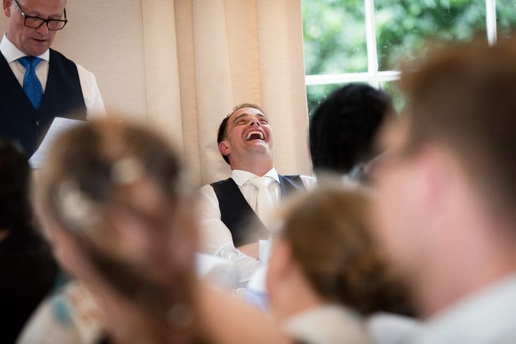 groom laughing during the speeches at Colwick hall nottingham