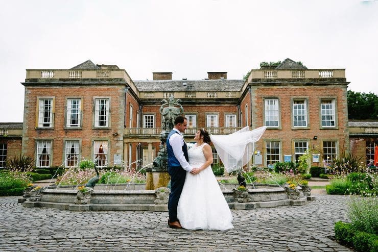 Ian and Jo got married at the Colwick hall hotel in Nottingham, this lovely photo of them together outside the front next to a fountain with her veil blowing in the wind