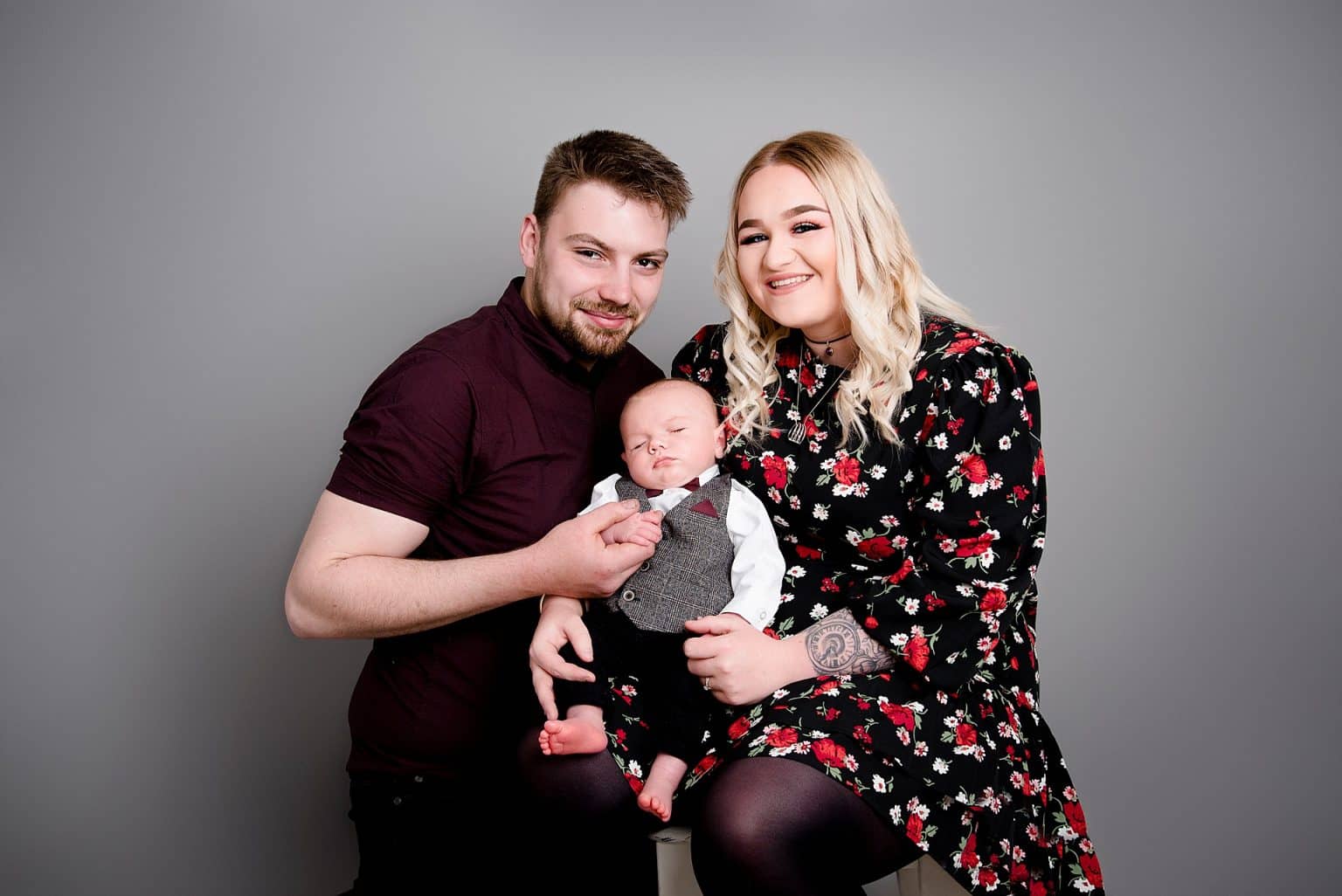 baby boy posing with parents