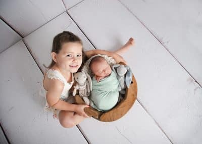 Newborn baby boy posing with his big sister