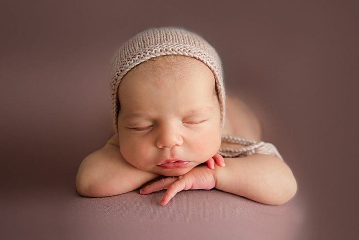 cute baby girl with chin on hands