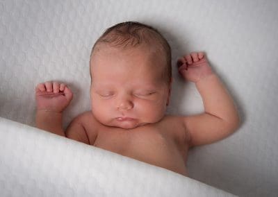 newborn baby boy on a white fabric