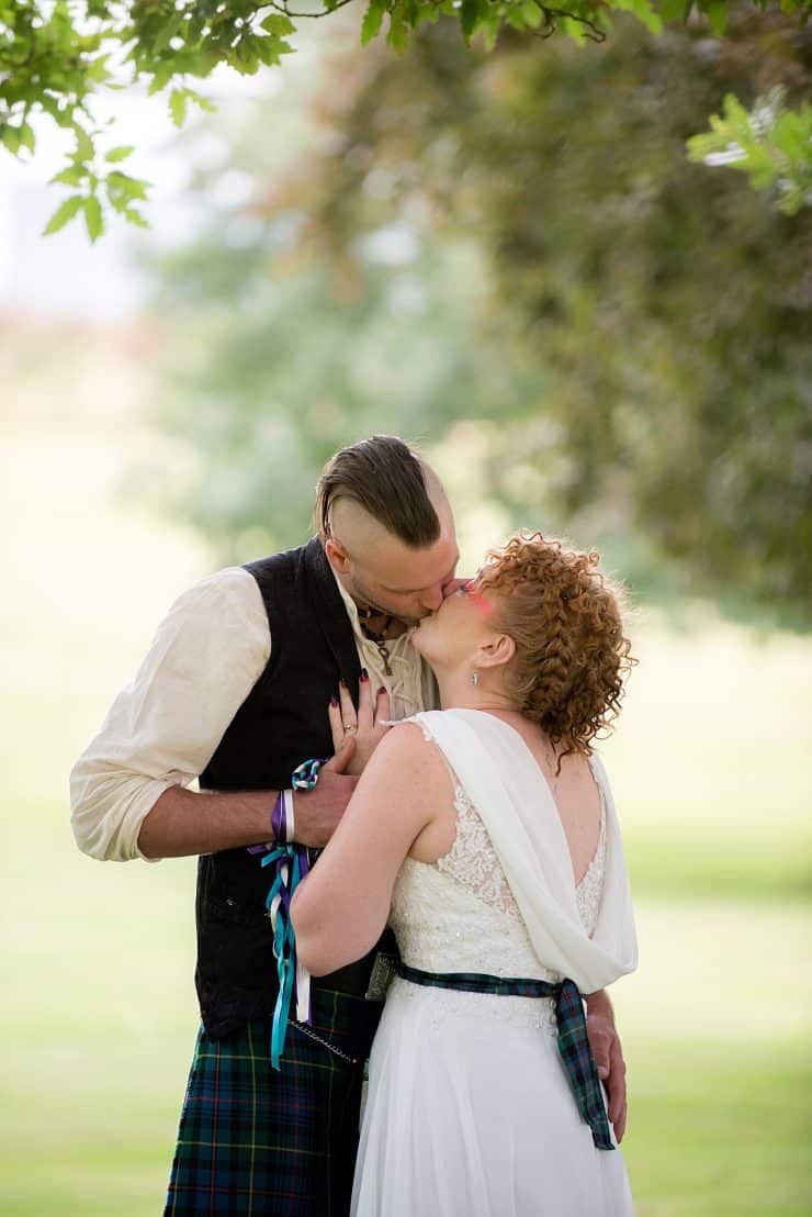 bride and groom kissing in the grounds at eastwood hall in nottingham