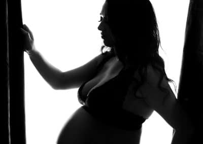 silhouetted photo of Gorgeous mum to be with her pregnant bump on her maternity pregnancy photo session with Rachael Phillips Photography in Mansfield, Nottingham