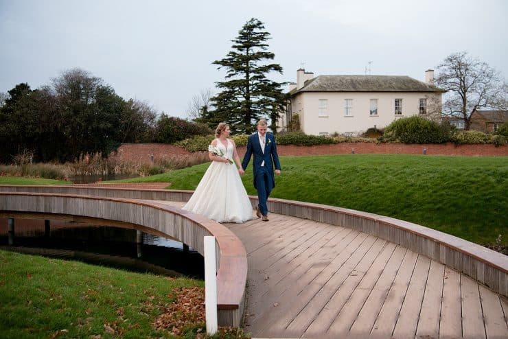 gorgeous couple walking over the bridge at The nottinghamshire golf course in nottingham