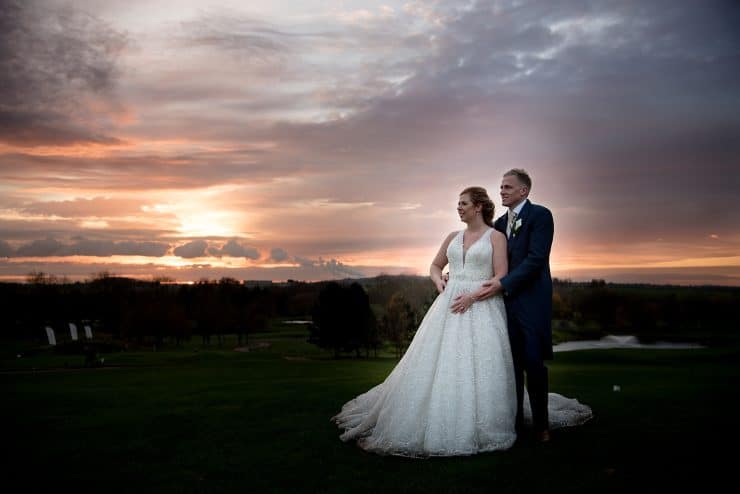 gorgeous couple with sunset behind them at The nottinghamshire golf course in nottingham