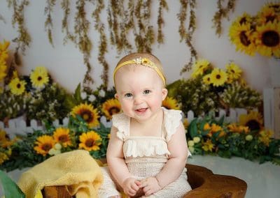 sunflower sitters session is so cute, little girl is laughing