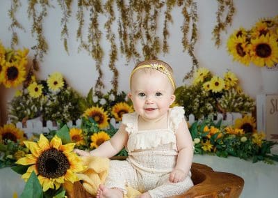 sunflower sitters session is so cute, little girl is smiling