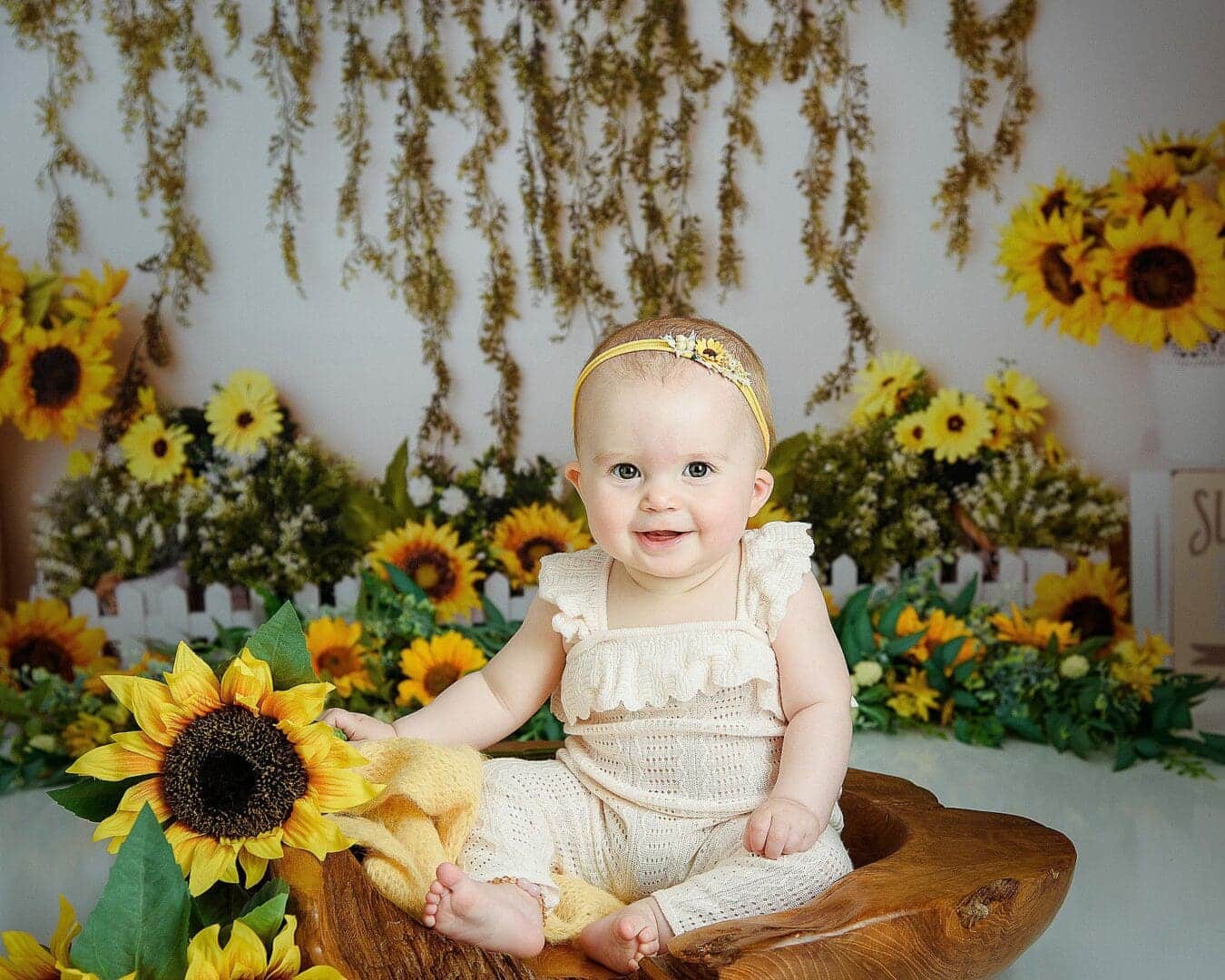 sunflower sitters session is so cute, little girl is smiling