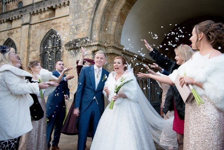 confetti at the bride and groom outside southwell westminster church