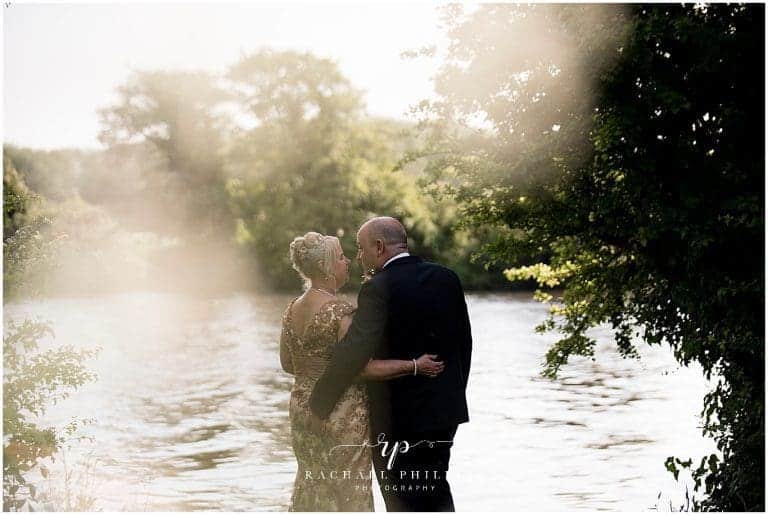 Bride and groom photo Taken over by the lakes at Colwick Hall hotel in Nottingham. Wedding Photographer, Rachael Phillips Photography - Nottingham and Derby Wedding Photographer.