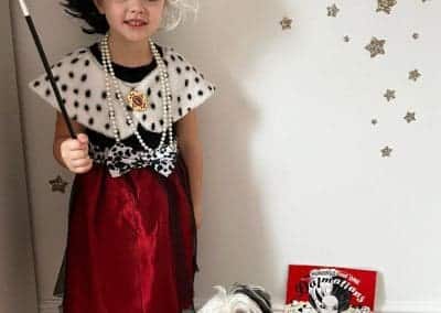 a little girl with her cute dog dressed up as crueller for world book day