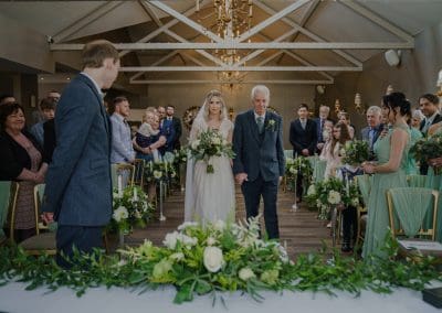 Adam and Sally at the alter to get married, surrounded by their friends and family at cockliffe country house photographed by nottingham wedding photographer and derby wedding photographer