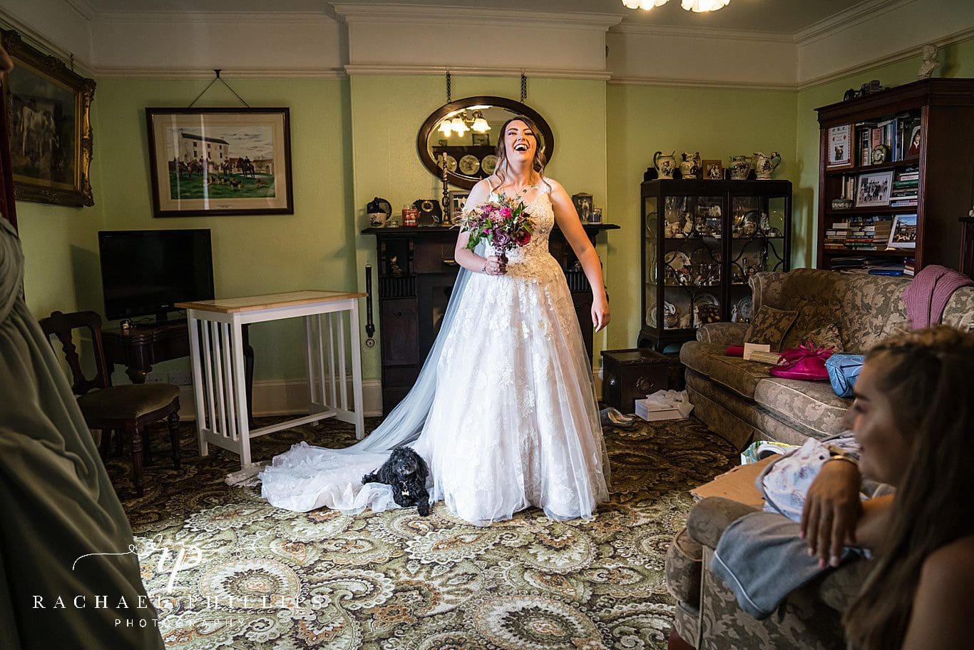 Bride laughing because the family dog went and laid on her wedding dress