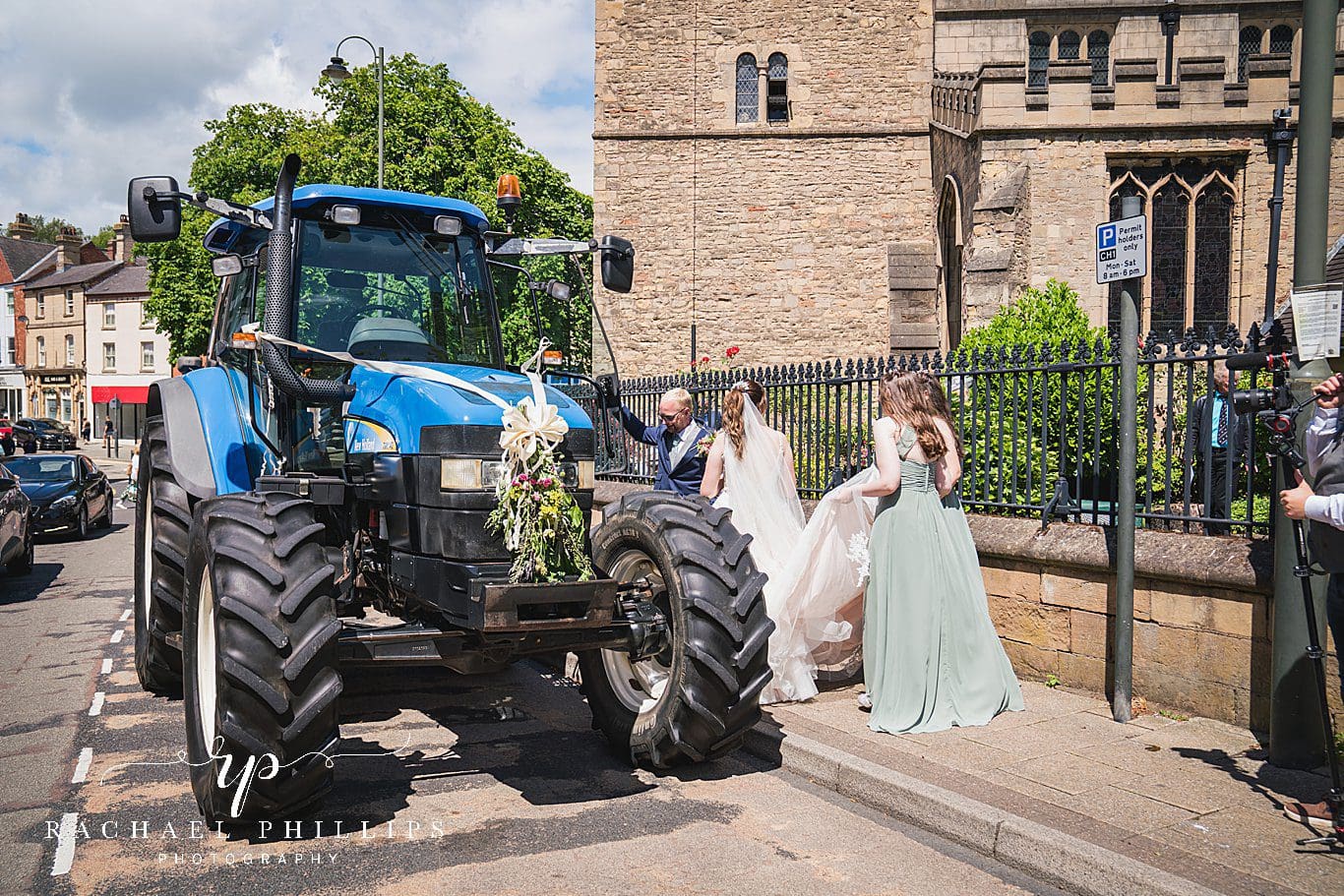 the bride and grooms transport to leave the church is a big blue tractor.