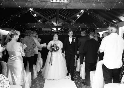 black and white photo of the bride and groom at as they leave the ceremony