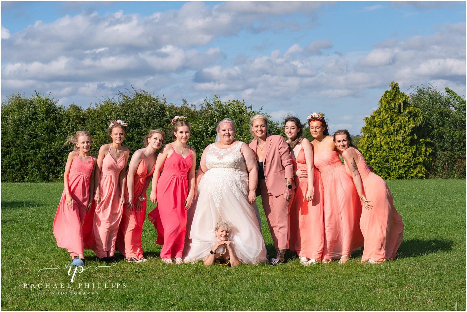 the bridal party looking fantastic, with a funny twist as one of the girls goes under the brides dress