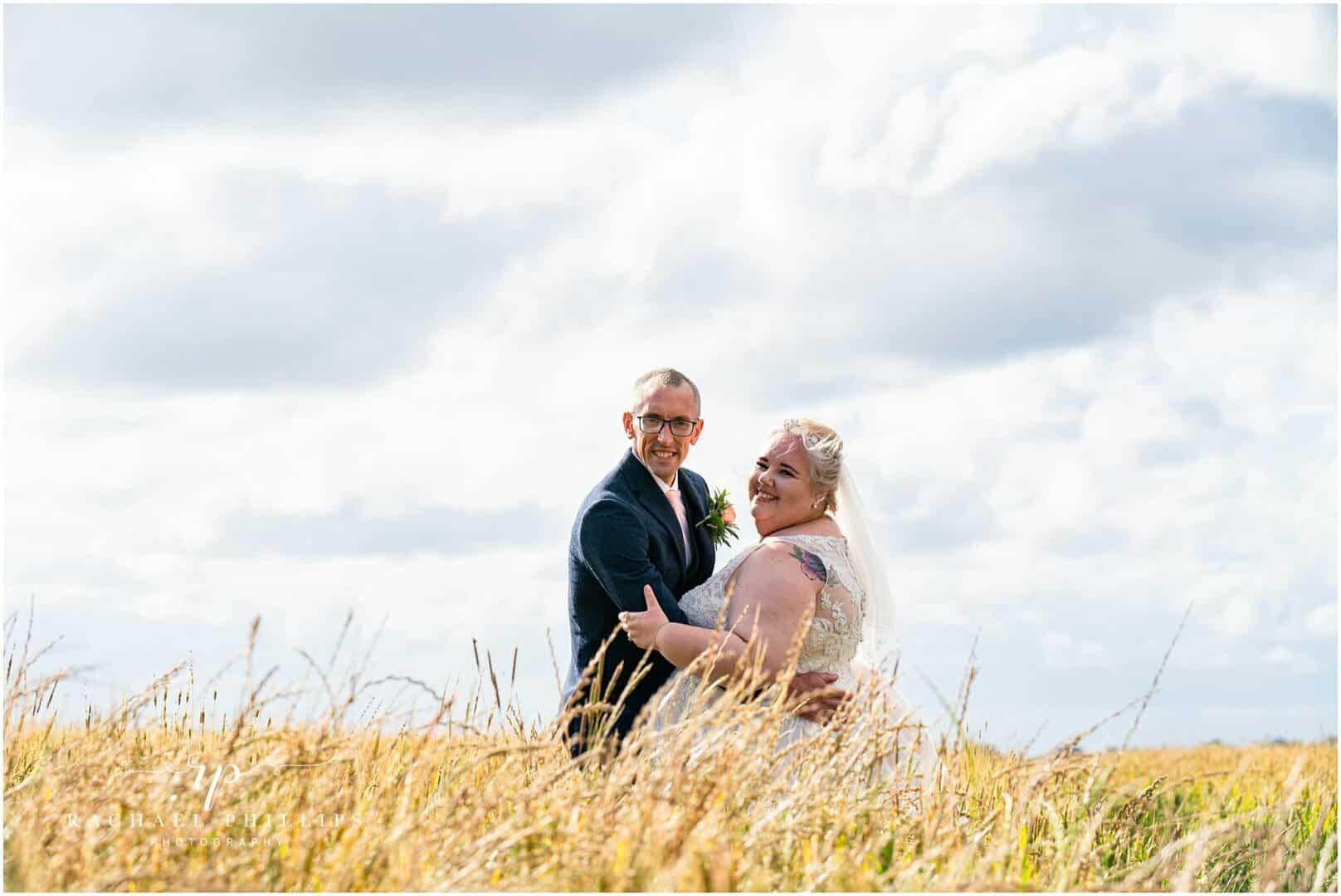 bride and groom in a corn field