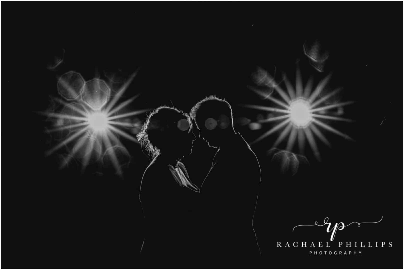 bride and groom on their wedding day with a bit of flash photography to make a double starburst behind them and then we have turned the photo to black and white
