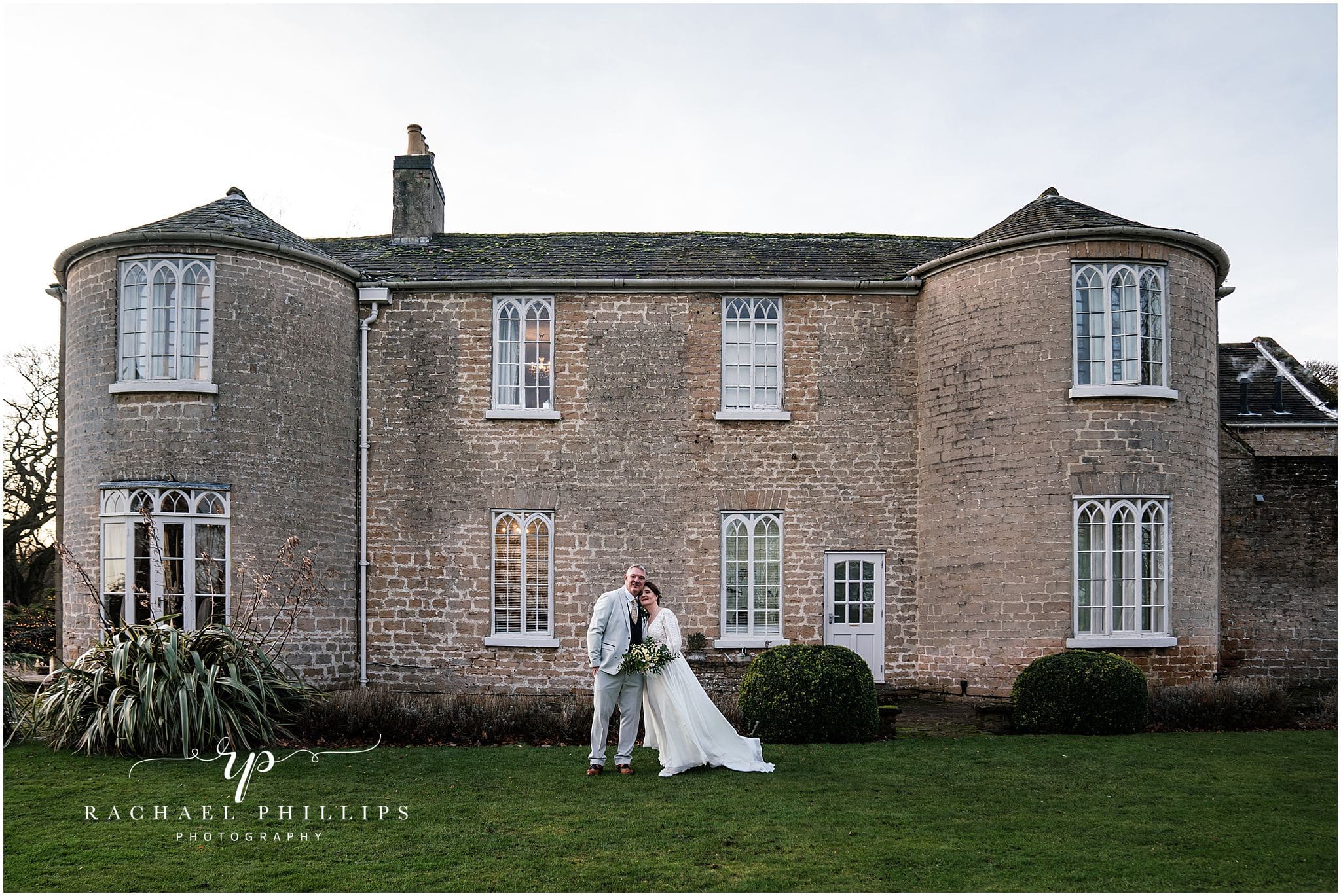 bride and grrom infront of cockliffe country house in nottingham for there winter wedding in december