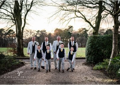 grooms men walk proudly up the drive to cockliffe country house, peaky blinders style
