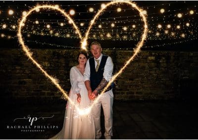 bride and grroom making a heart with sparklers on there wedding day at Cockliffe country house in Nottingham, photo taken by Rachael phillips photography