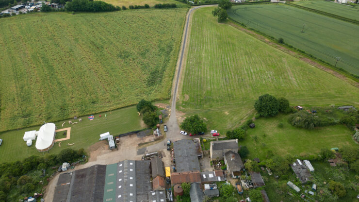 Aerial view of fields and countryside buildings.
