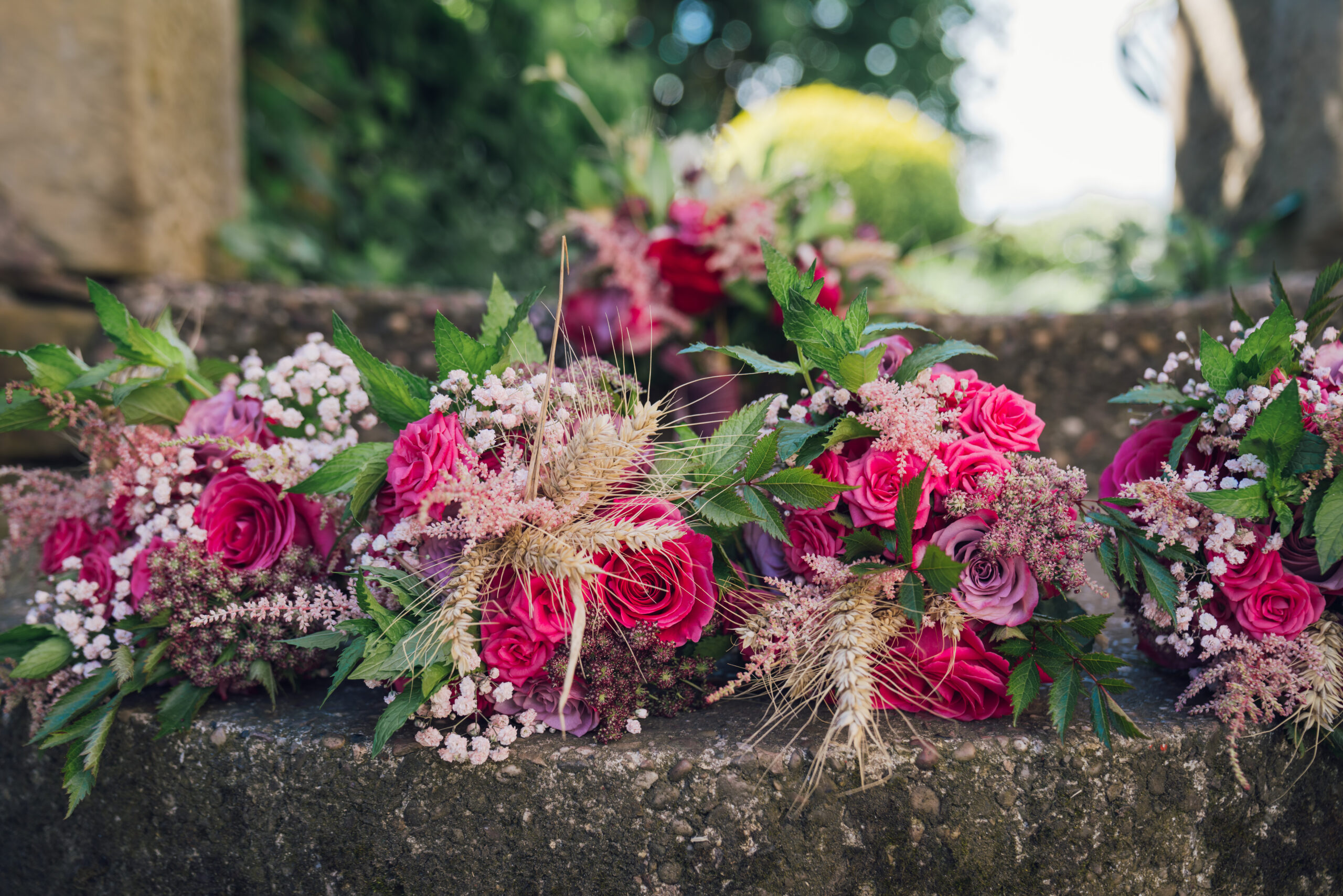 Pink and purple floral arrangement on stone steps