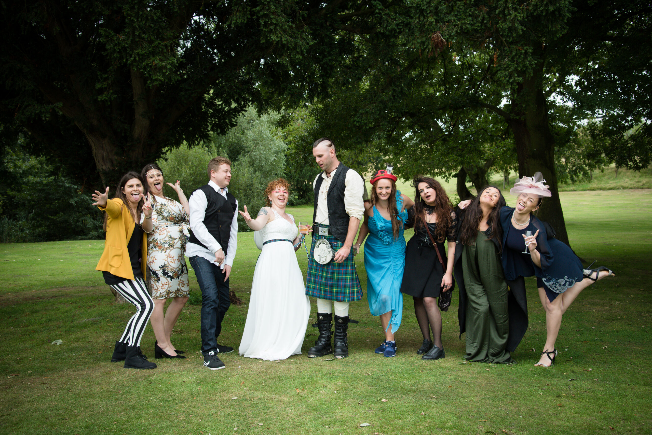 Group celebrating at outdoor event in festive attire.