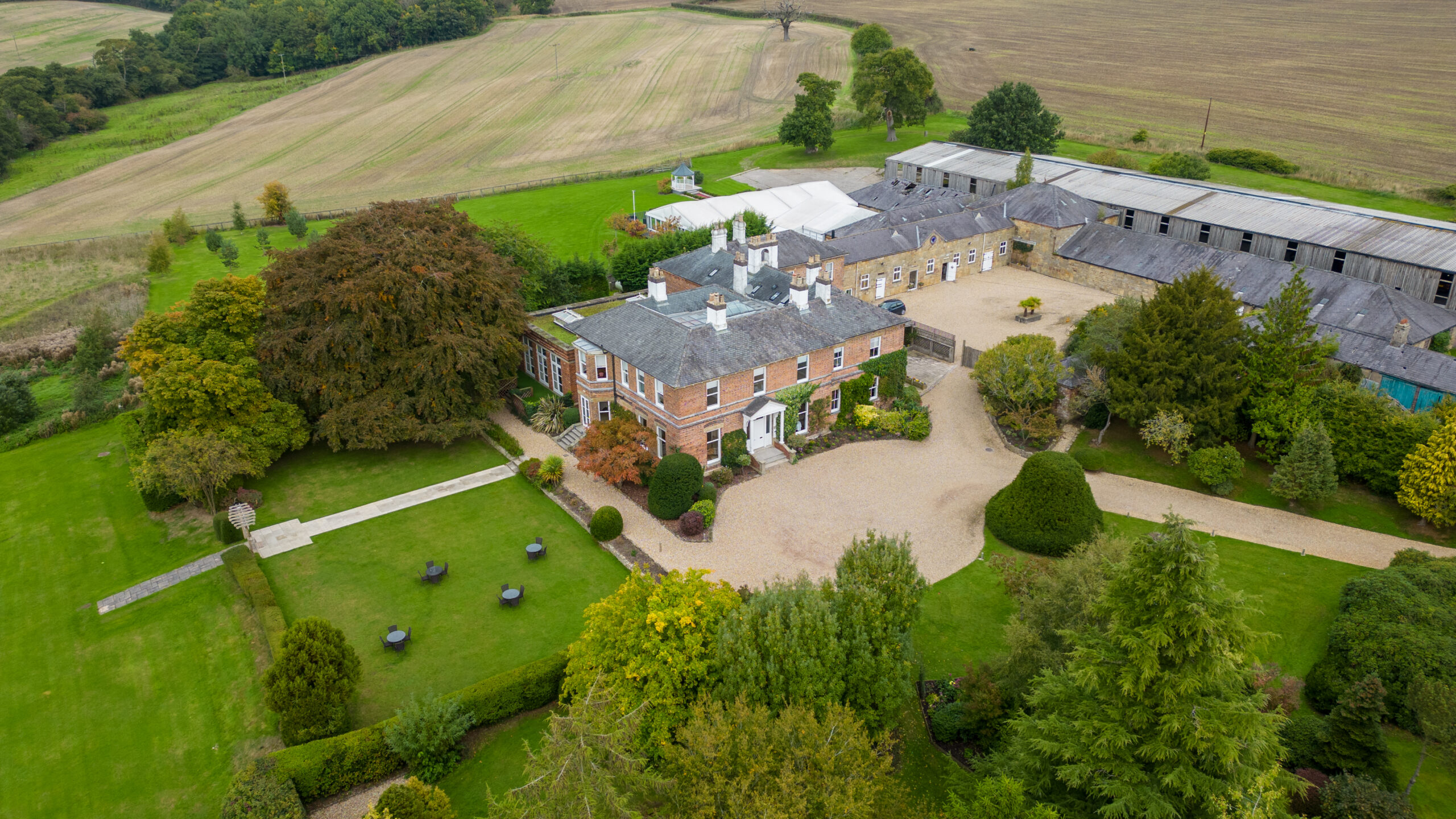 Aerial view of country estate with gardens.