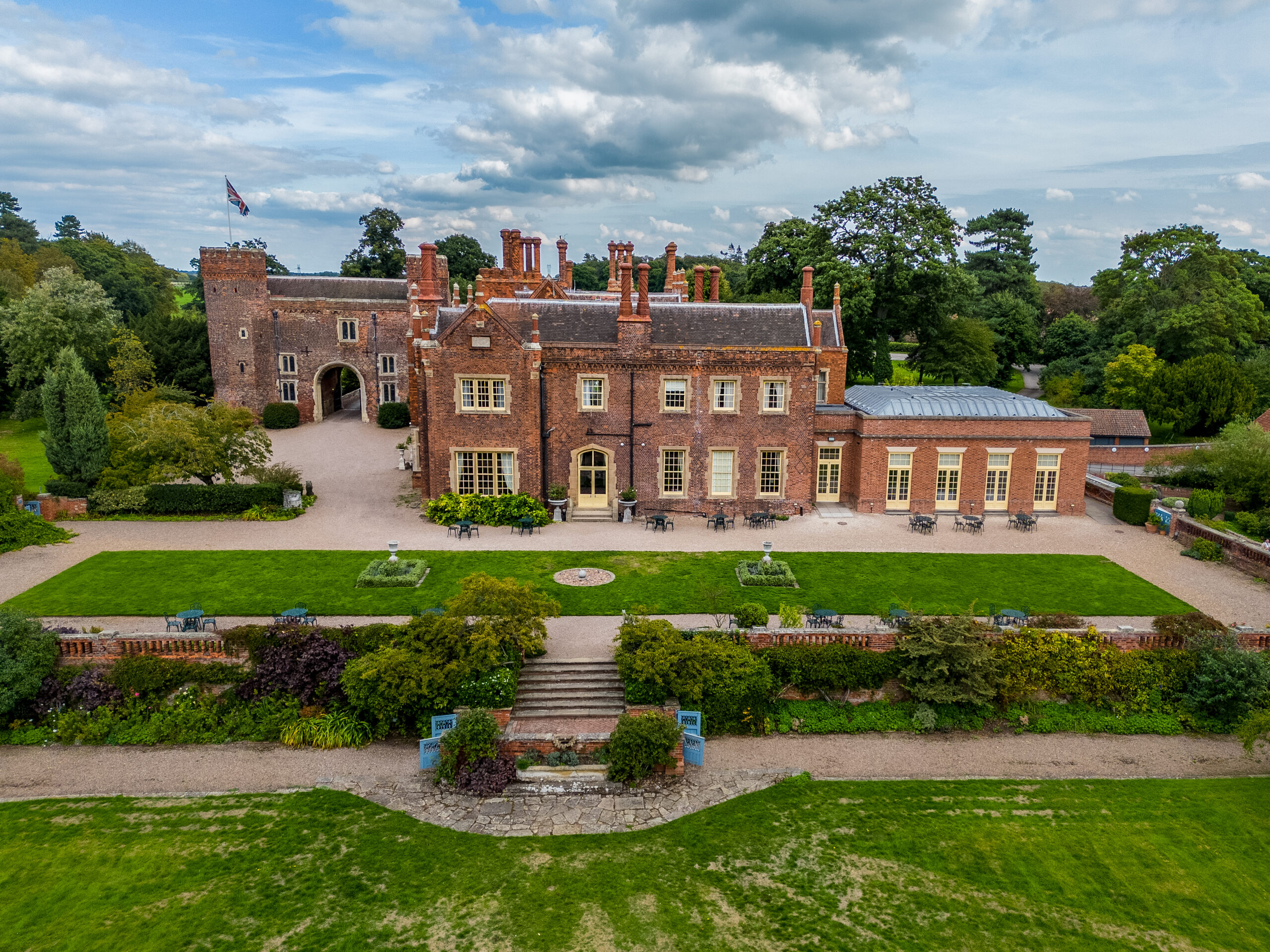 Historic English manor with manicured gardens.