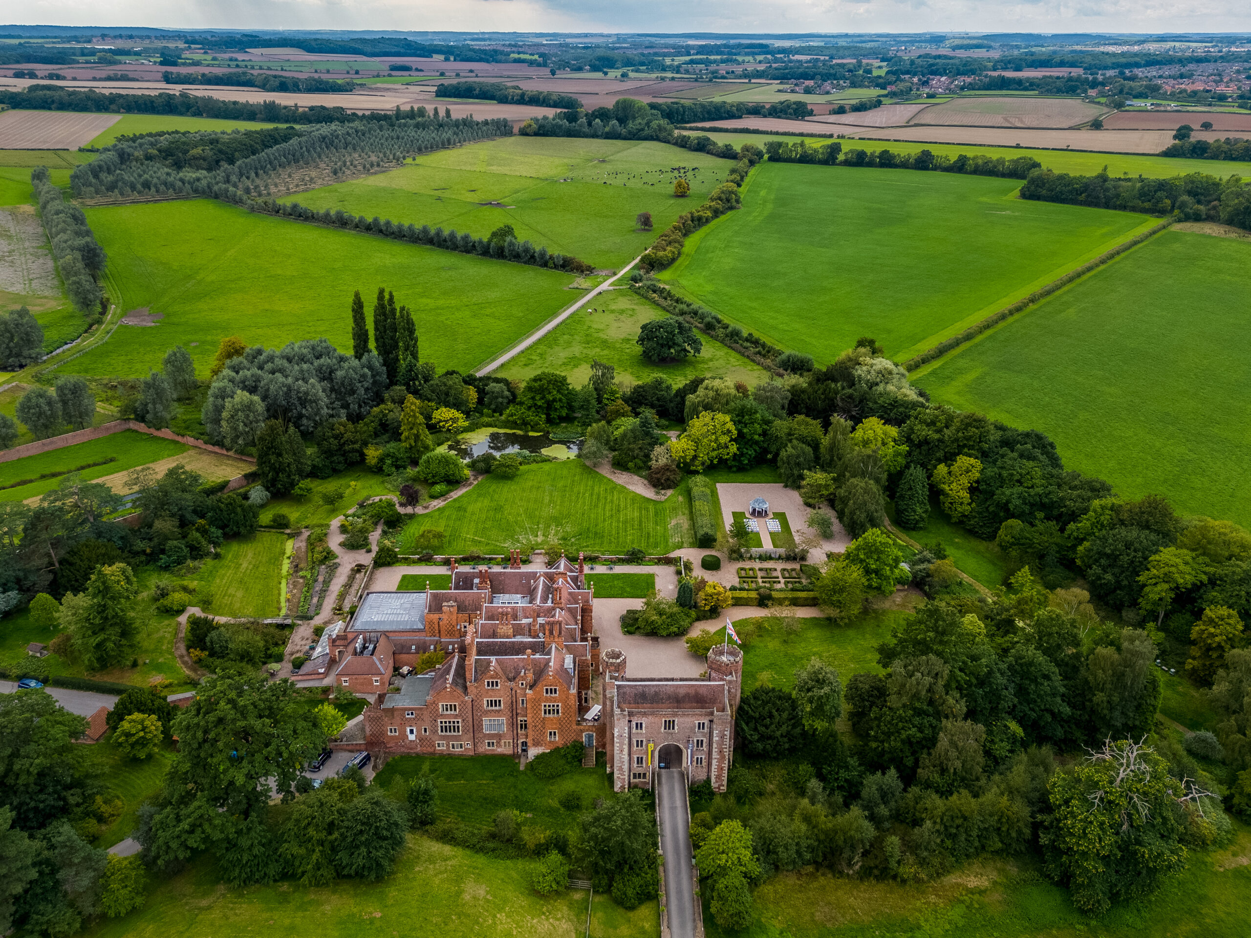 Aerial view of English countryside with historic manor.