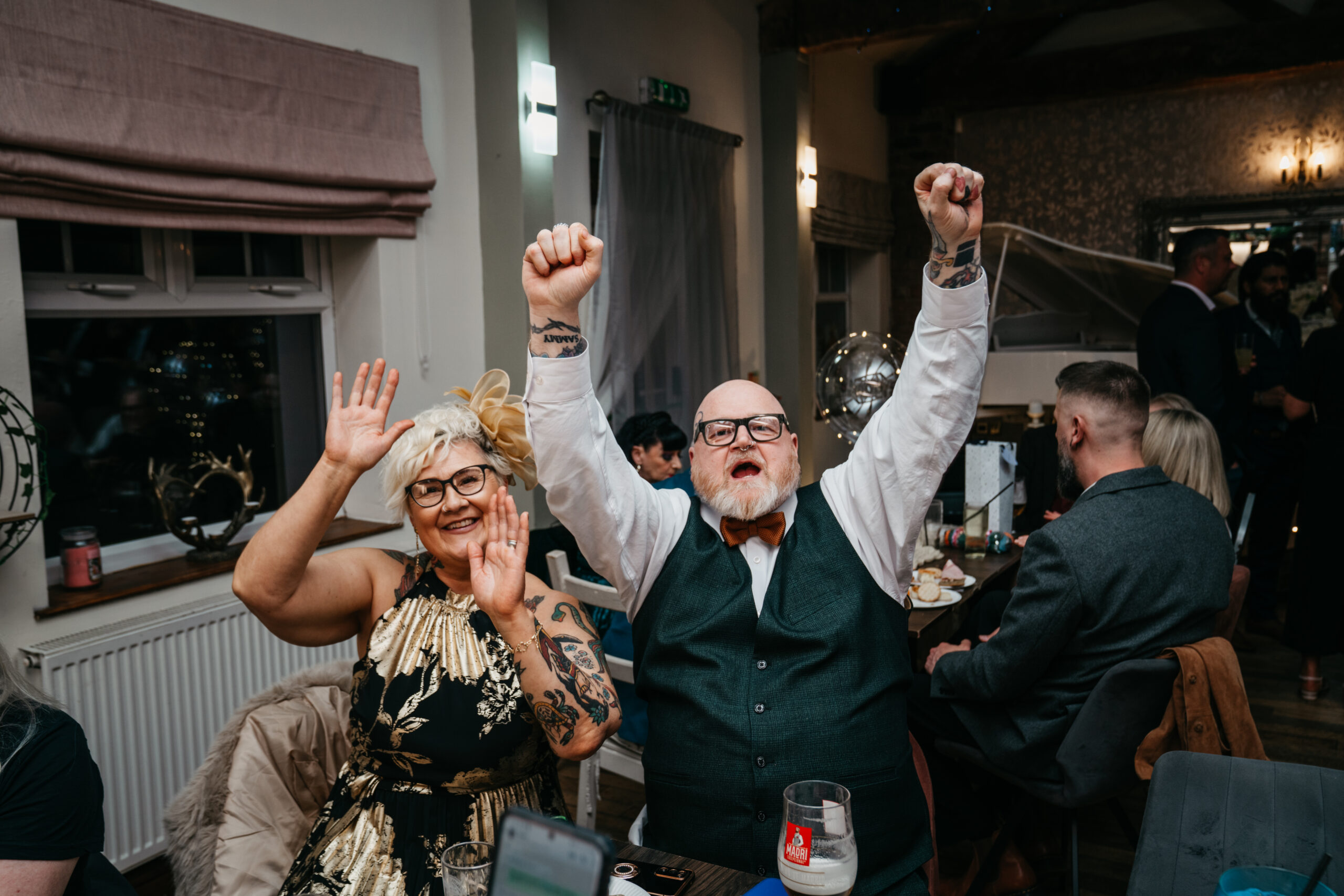 Cheerful couple celebrating at a social event.